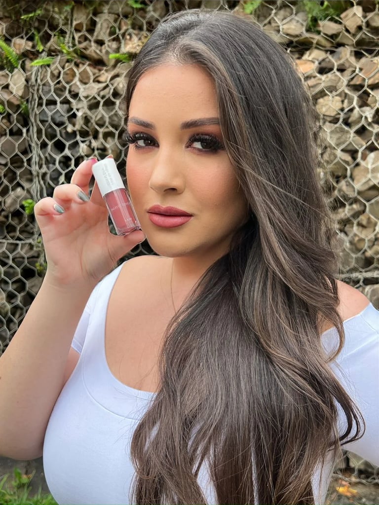 a woman with long hair and a white shirt
