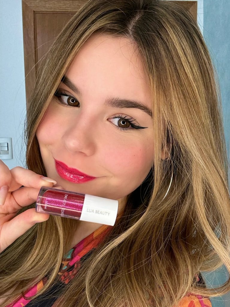 a woman with long hair and a pink lipstick