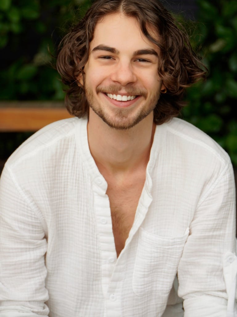 a man with a beard and a white shirt