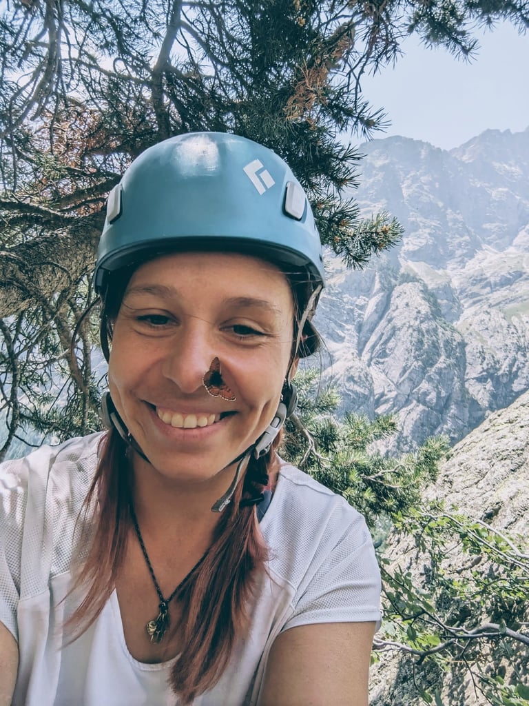 a woman in a helmet on a mountain