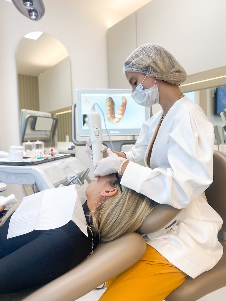 a woman dentist is sitting in a chair in a dental room attending a patient
