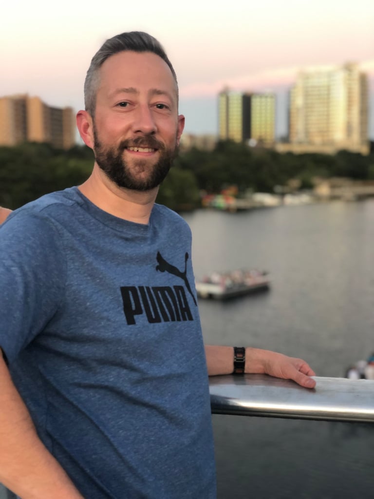 a man with a beard and a blue shirt