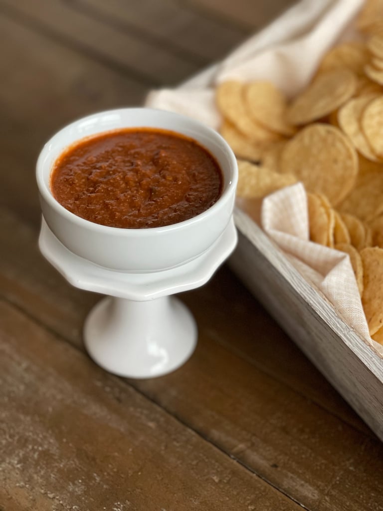 "Do the Dance" Hot salsa in a bowl beside a container with tortilla chips