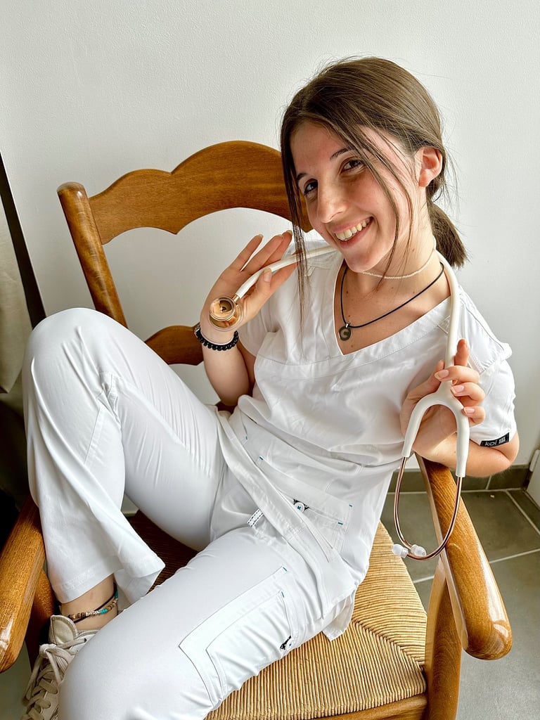 a woman sitting in a rocking chair with a donut