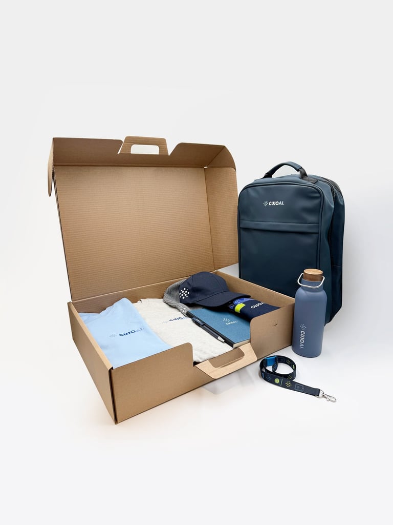 A corporate gift box set containing a branded backpack, water bottle, apparel, and stationery on white background.
