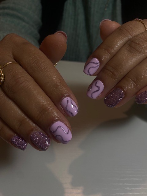 a woman's hands with a purple manicured manicured manicure