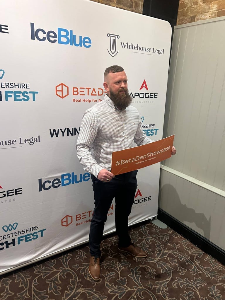 the owner of cafine skincare holding a BetaDen sign