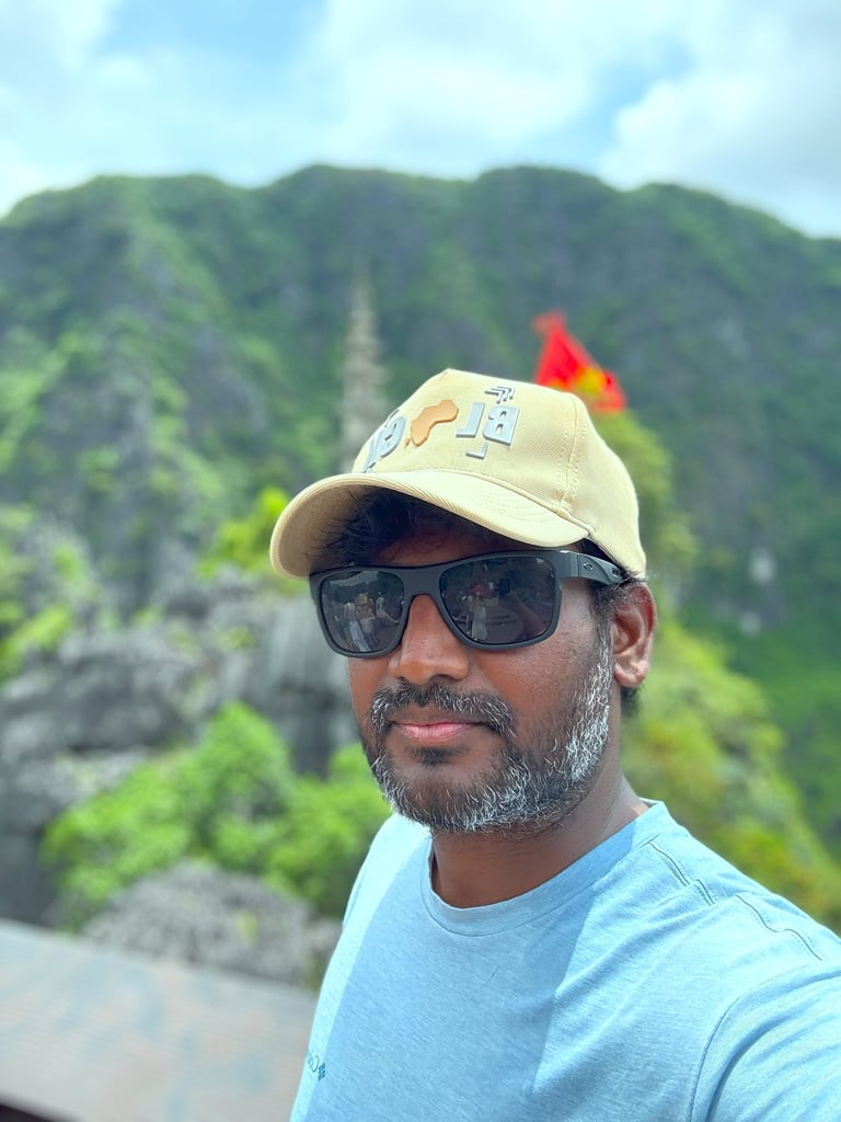 a man in a blue shirt and sunglasses