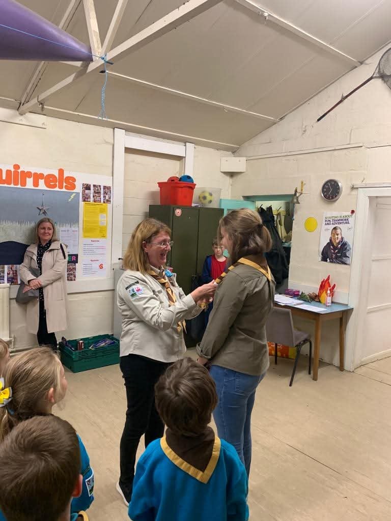 A young leader is invested in Scouts in Grassendale