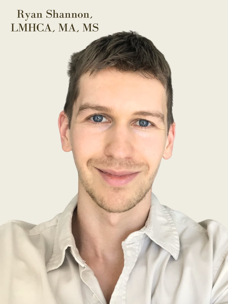 Professional headshot of Ryan Shannon, LMHCA, a therapist smiling in a collared shirt against a neutral background.