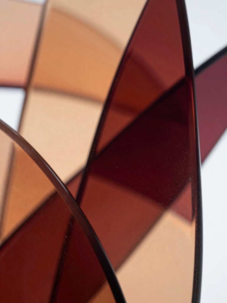 Crisp macro shot of abstract fluid glass shapes reflecting warm orange and deep maroon light, soft studio lighting, clean geometric lines, high depth of field.