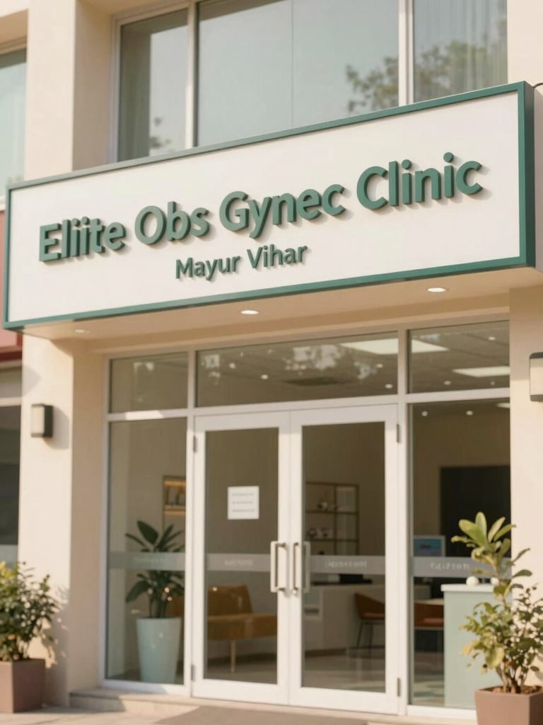 Exterior shot of Eliite Obs Gynec Clinic entrance in Mayur Vihar, Delhi, showing clear signage, bright and welcoming, soft natural light.