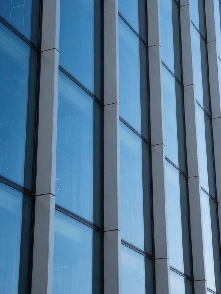 Macro photograph of architectural glass panels reflecting high-contrast daylight, sharp geometric lines, cobalt blue tones, 35mm