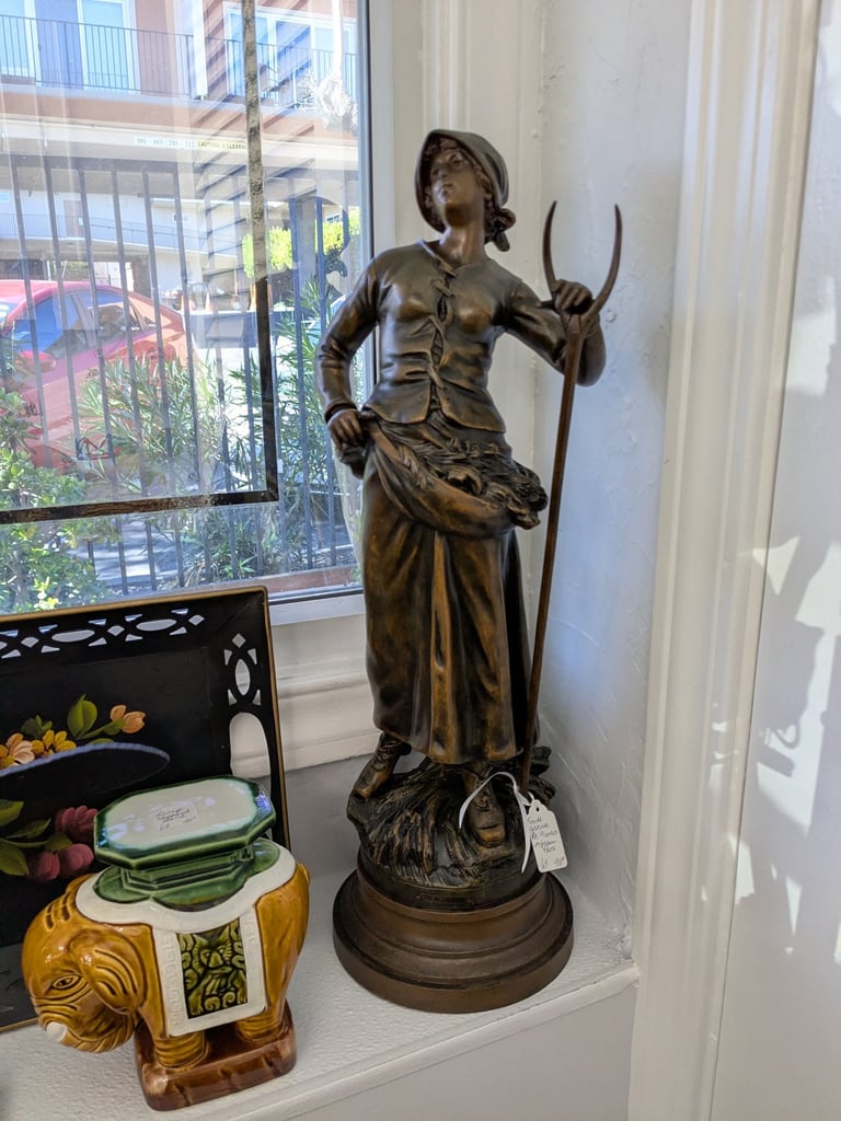 Antique bronze statue of a peasant woman.