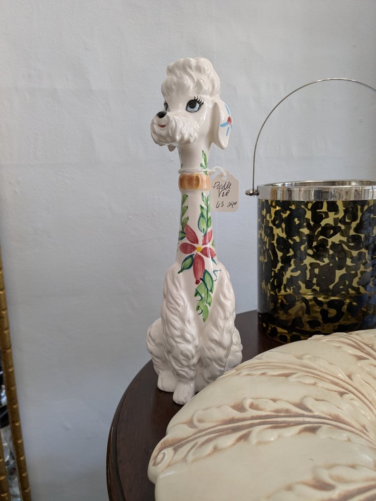 Vintage white ceramic poodle figurine with floral hand-painted details on a long neck.
