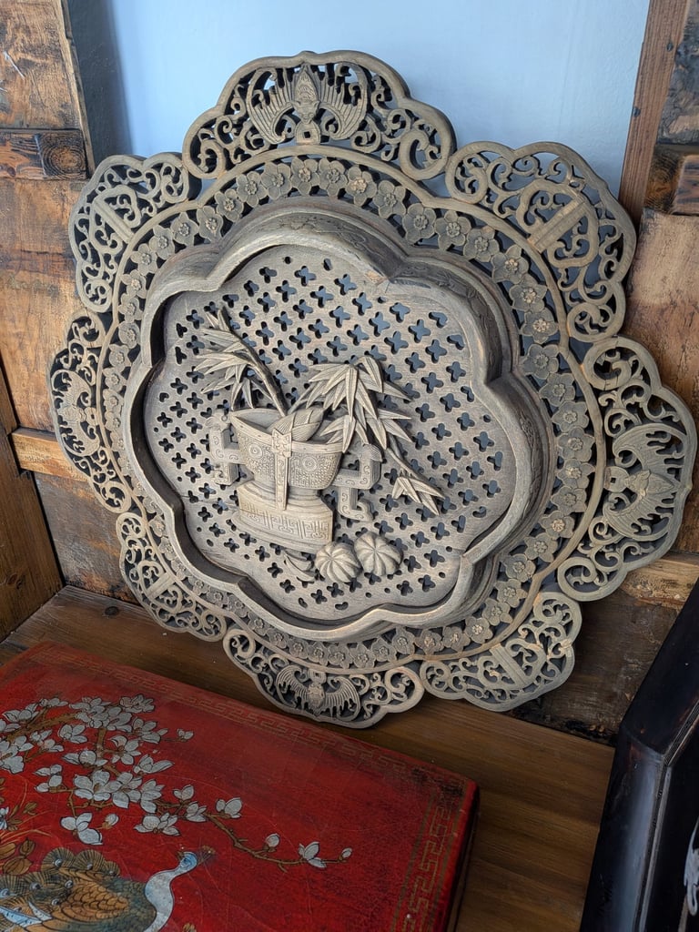 Ornate Chinese wood wall plaque featuring intricate floral and bamboo patterns.