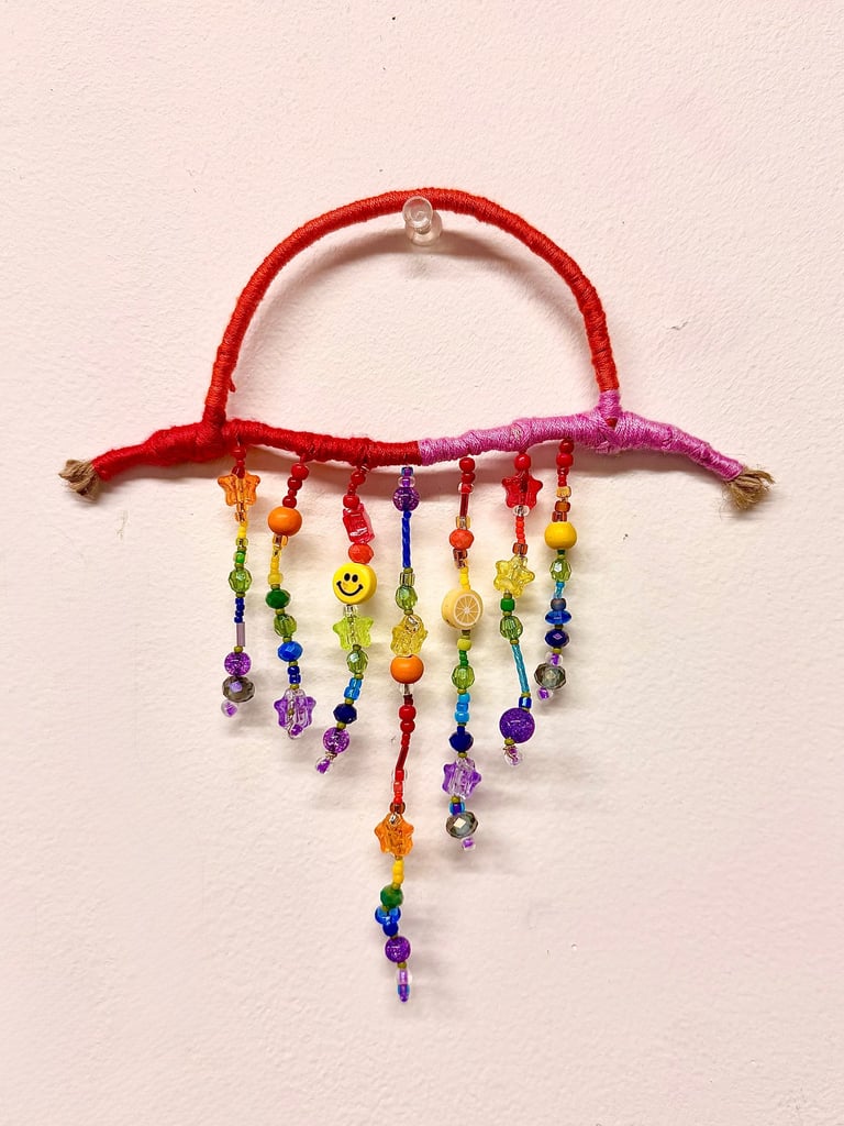 Woven beaded rainbow wall hanging