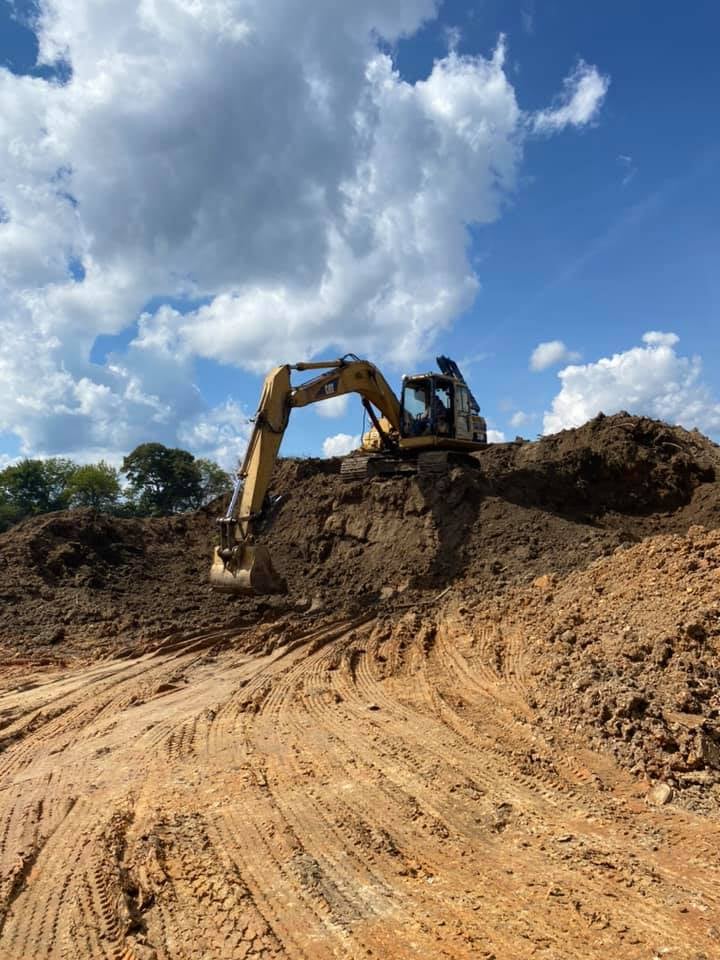 Large Excavator digging out land area, excavating