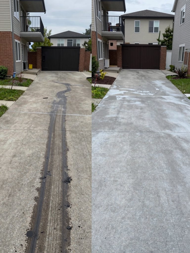 Split before-and-after frame of a concrete driveway near a Brossard condo building — left half shows dark oil stains and rubber marks, right half shows the same surface freshly pressure-washed to clean pale grey, photographed under flat overcast daylight for accurate color contrast