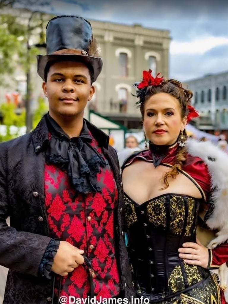 Justin Cale II and Overslady in Victorian Garb with a top hat and corset at a dickens on the strand