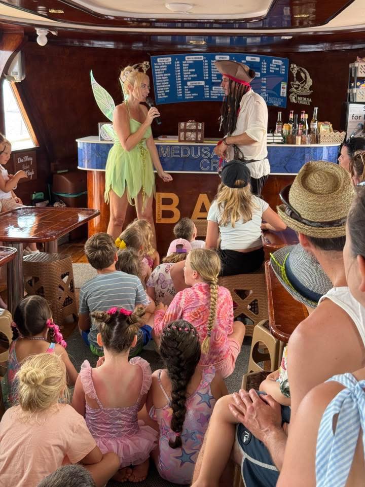 Fairy and pirate entertaining children on a family boat tour in Cyprus