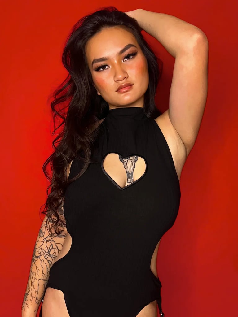 A woman in a black bodysuit