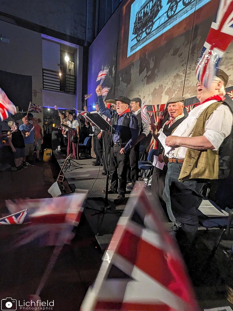 Crowd waving union flags at Sandfields Pumping station