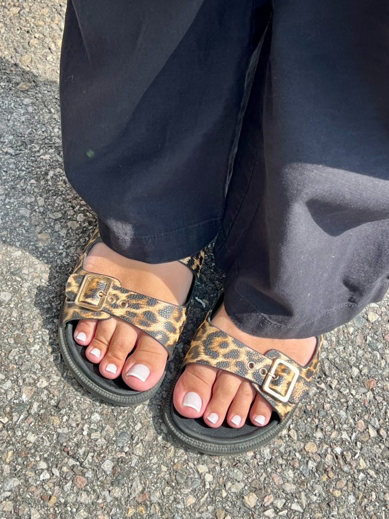 a person wearing a leopard print sandals and a leopard print sandals