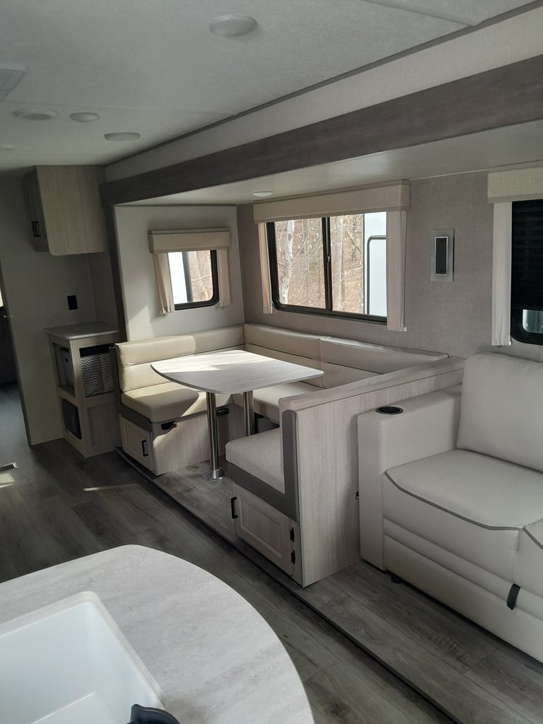 Interior living area of temporary RV housing for comfortable extended stays during home repairs