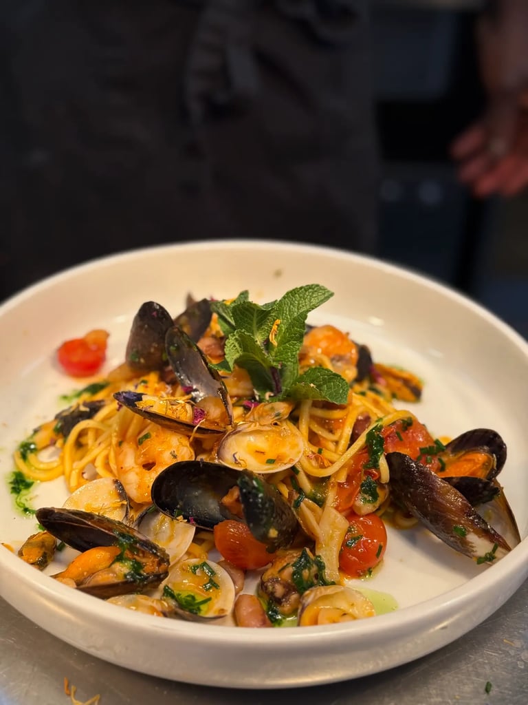 a plate of pasta with musselling and musselling