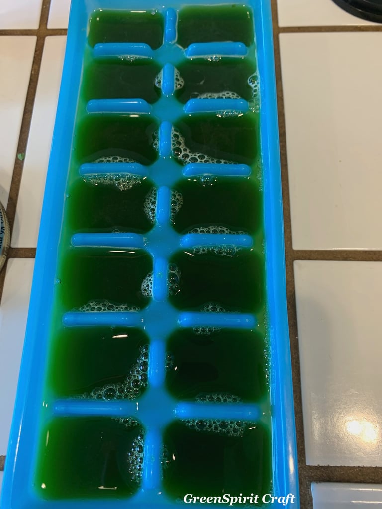 Cleavers juice filling up a blue plastic ice cube tray