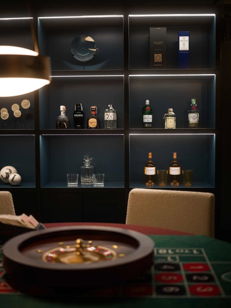 Cigar lounge at Villa La Gratitud with backlit shelves and roulette table