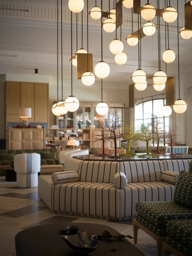 Main salon at Villa La Gratitud with sculptural lighting and striped circular sofa