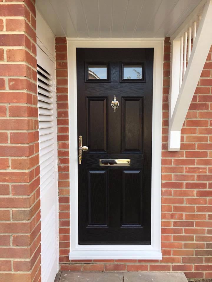 A black 4 panel 2 square door on ref bricks in black fitted in Gosport by Buildmydoor