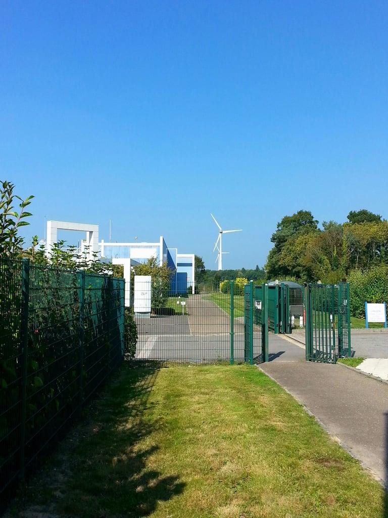 a gated in area with a fenced in area with a wind turbine