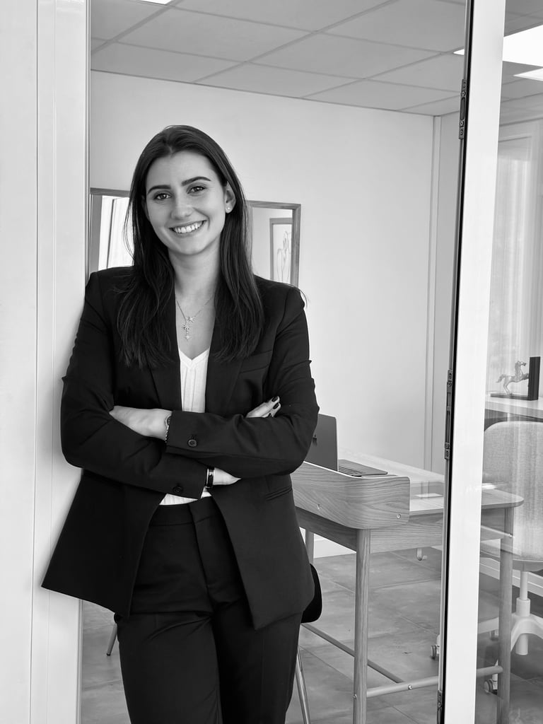 a woman in a suit and tie smiling for the camera