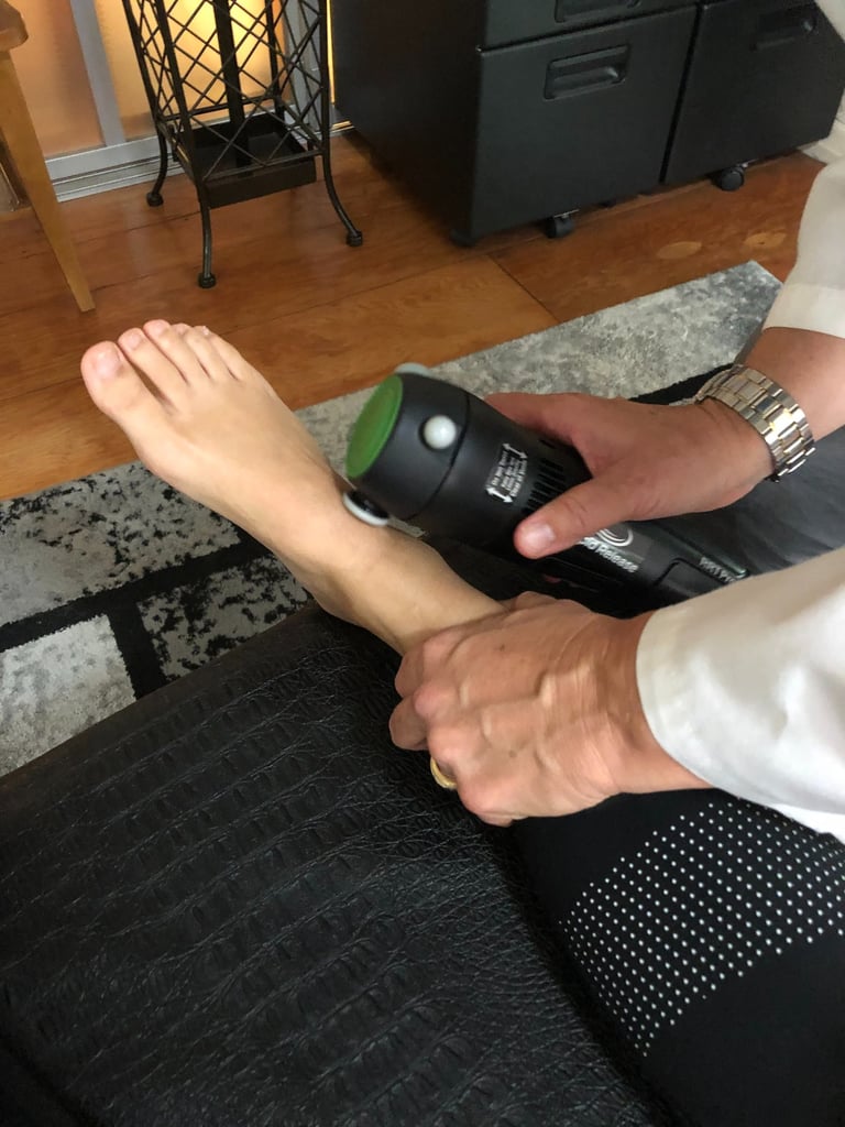 Dr. Lonna Denny peforming a cold laser therapy to her patient's ;eg/