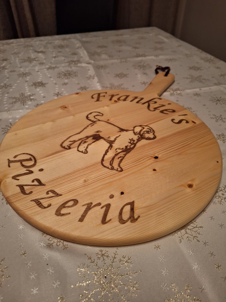 a wooden pizza board with a dog on it