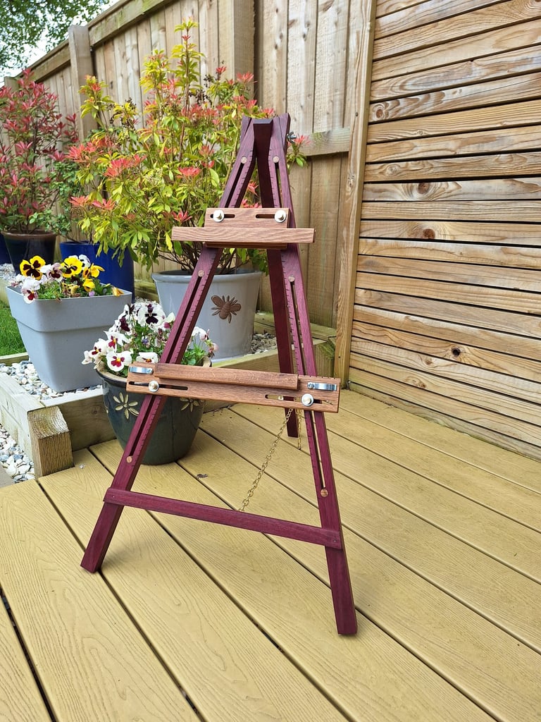 an artists easel on decking in a garden