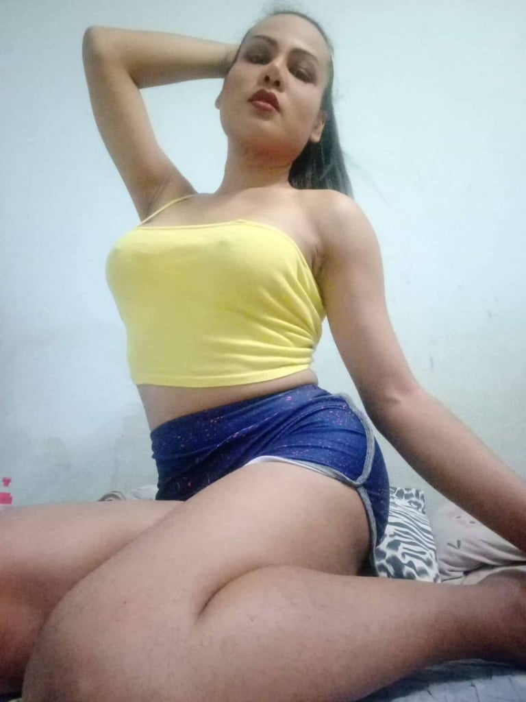 ladyboy therapist wearing short yellow top and blue shorts
