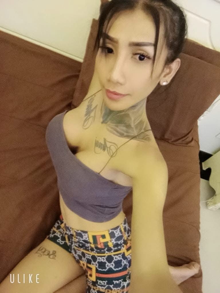Ladyboy Pattaya home massage therapist sat on a sofa