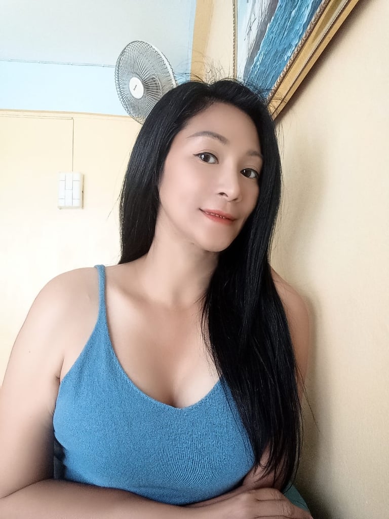 half body photo of a lady with long black hair and a blue crop top