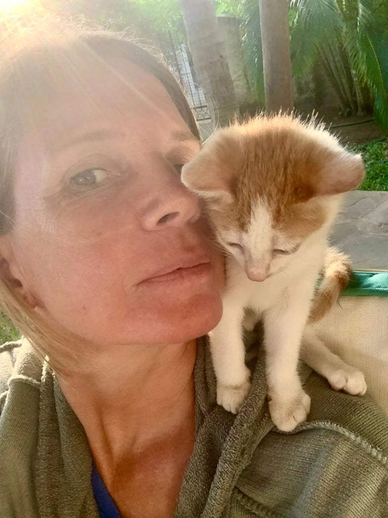 Fran is holding a kitten on her lap