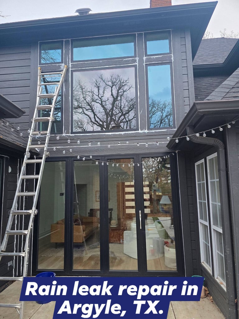 Giant windows getting sealed on a two story house in Argyle, TX