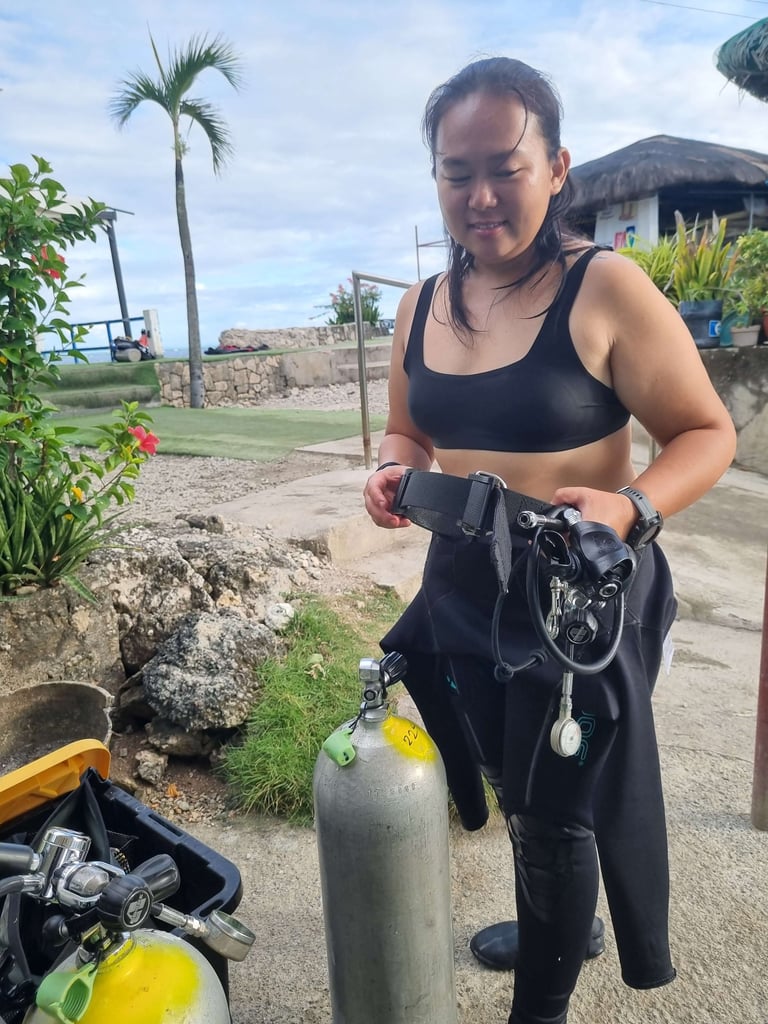 Sugbudiver setting up her dive gear for scuba diving