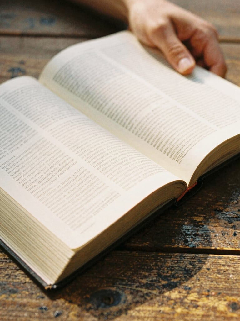 Close-up of hands holding an open Bible on a rustic wooden table, warm golden hour light illuminating the pages, shallow depth of field, 35mm film look