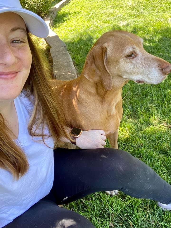 girl with a dog next to her