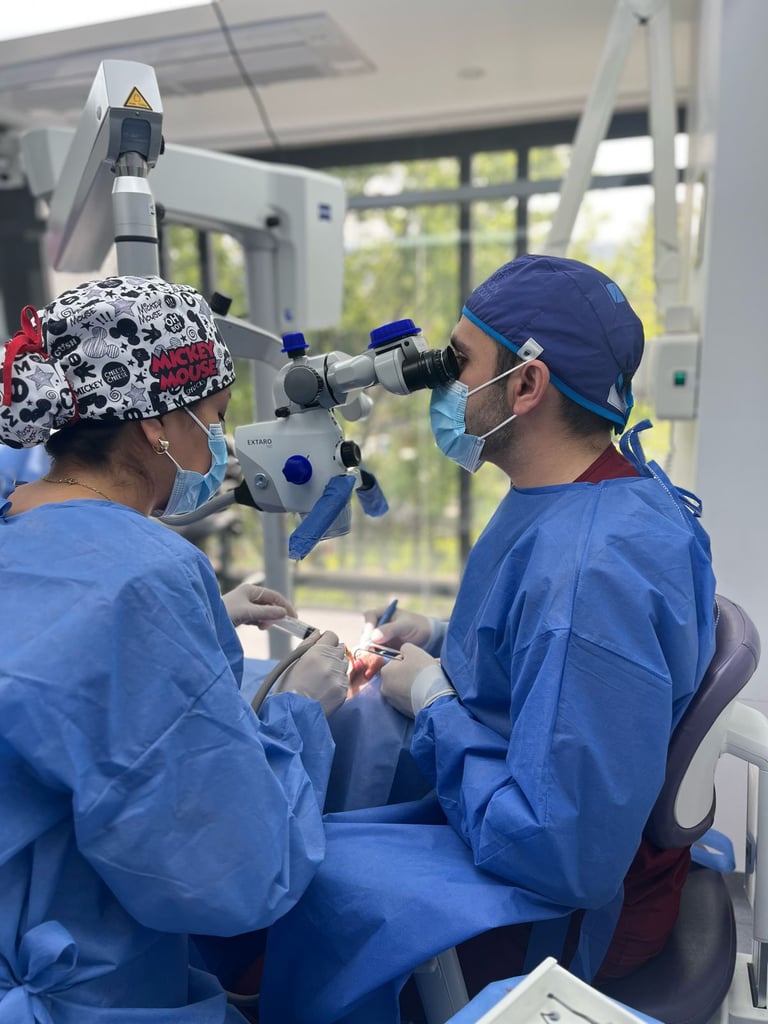 Professional dentist performing a root canal treatment using a high-precision dental microscope.