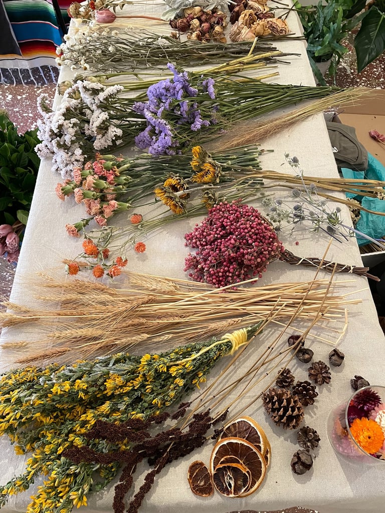 a table with a bunch of dried flowers