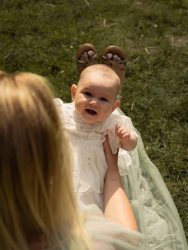 mother holding her baby on her lap